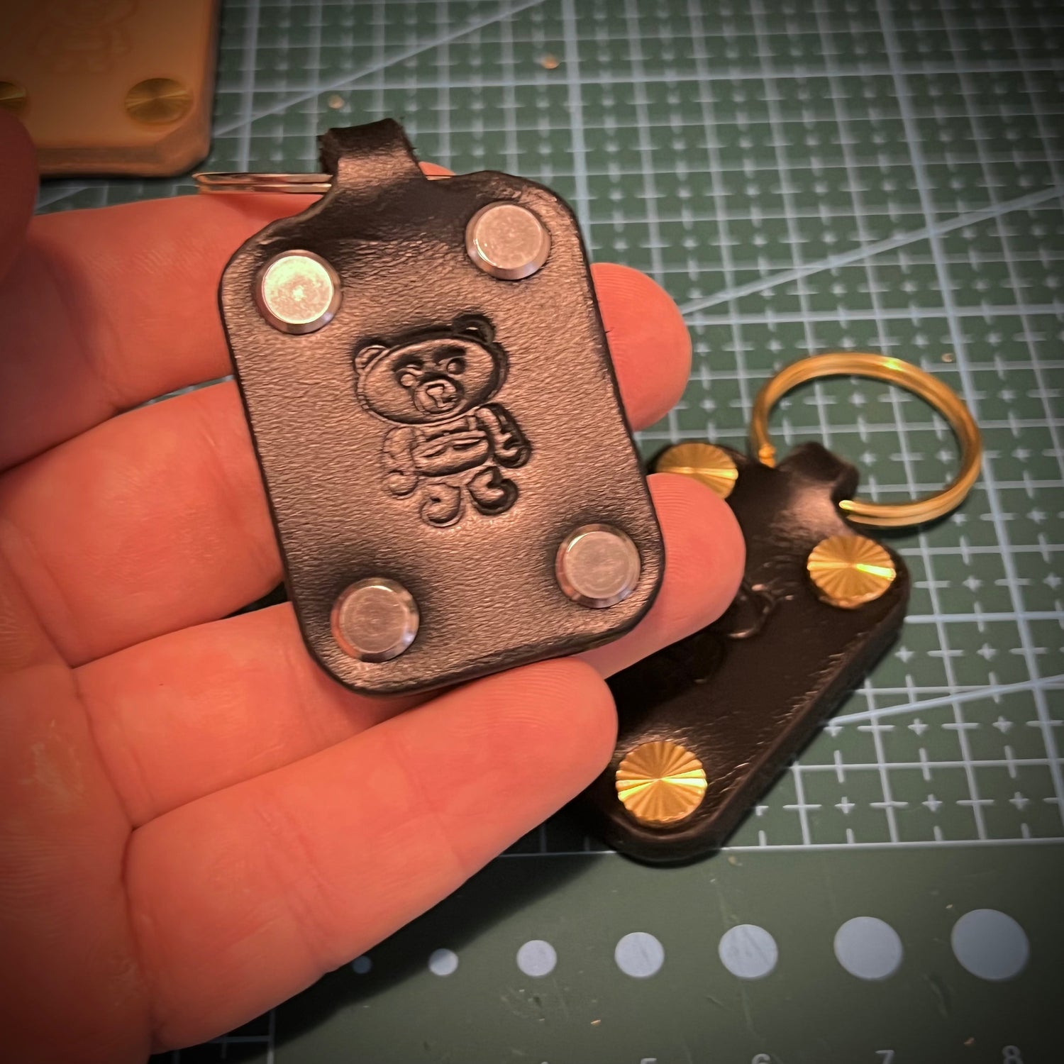 Black leather keychain with a bear stamp