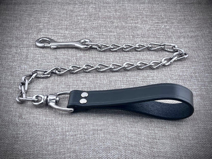 Dog leash with metal chain on a gray textured background