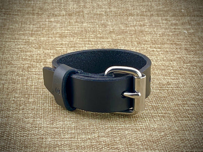 Front studio view of a handcrafted 1" wrist cuff showcasing premium vegetable-tanned cowhide leather, high-grade Nickel Plated Steel hardware, and hand-beveled and burnished edges.