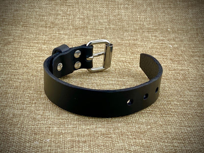 Profile perspective of a handcrafted 1" wrist cuff showcasing heavyweight 8oz American belt-weight leather, polished hardware surfaces, and sleek burnished edge construction.