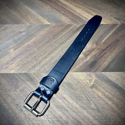 Product reveal of a handcrafted 1.25" black leather wrist cuff showcasing premium vegetable-tanned cowhide and steel buckle hardware.