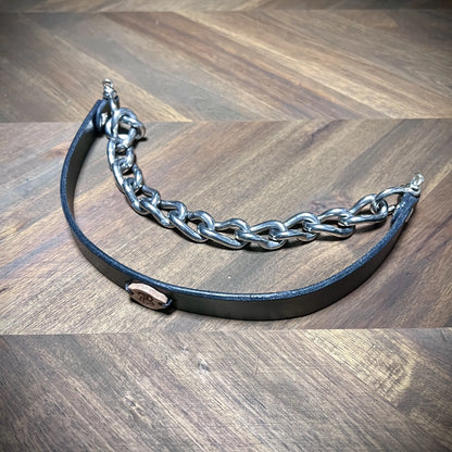 Hero tilt view of a handcrafted black leather alternative collar featuring an integrated heavy steel chain and natural leather maker tag.