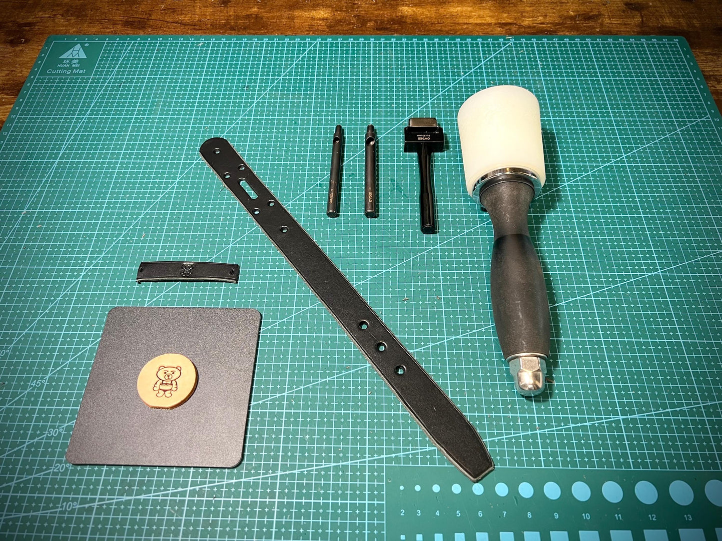 Set of leatherworking tools on a green cutting mat