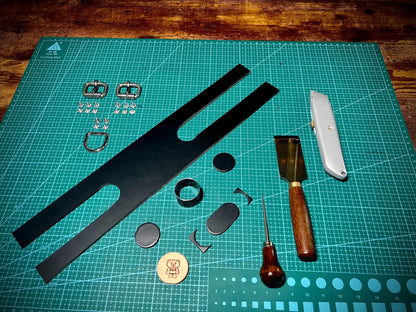 Set of leatherworking tools and materials on a cutting mat