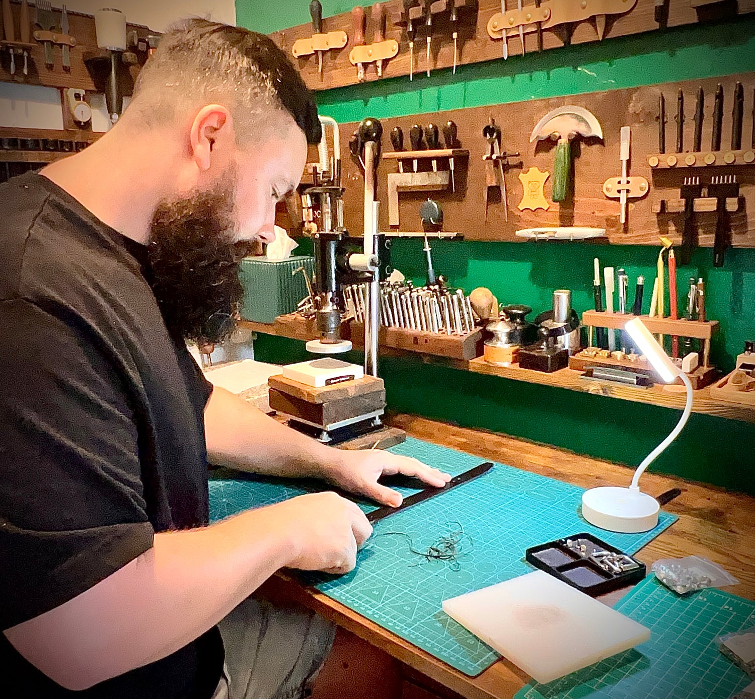 Master working on made-to-order leather piece