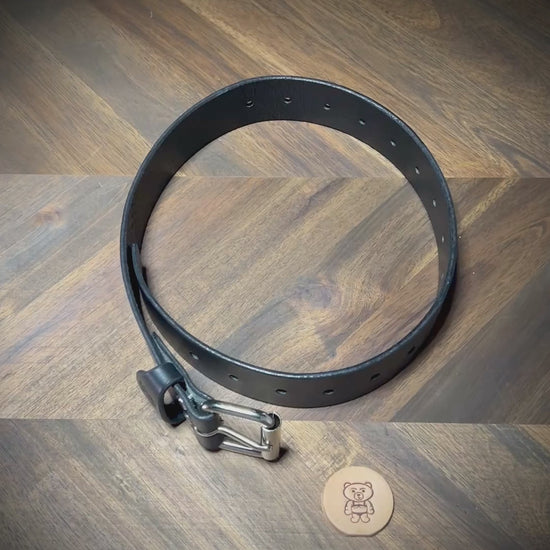 Manual demonstration unbuckling black leather restraint.