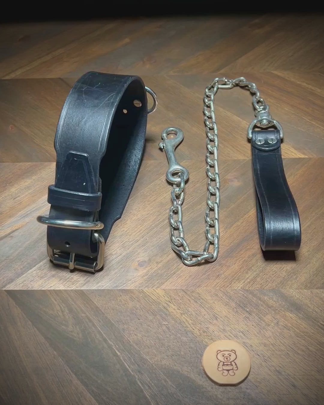 Demonstrating the flexibility and buckle fastening of a 1.75" black leather collar with nickel-plated steel hardware.