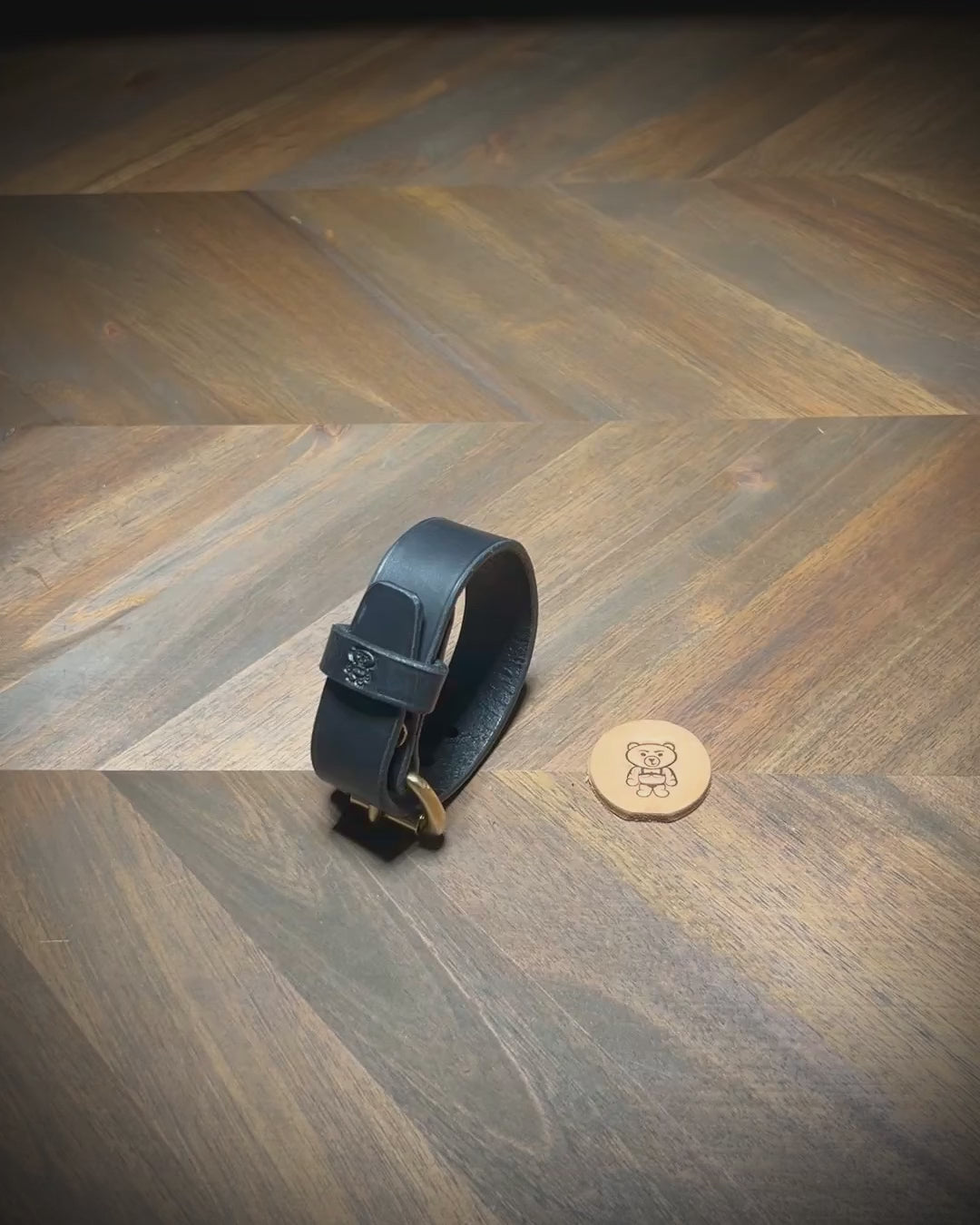 Demonstrating the unbuckling of a 1" black leather cuff to reveal the interior grain and solid brass hardware parameters.