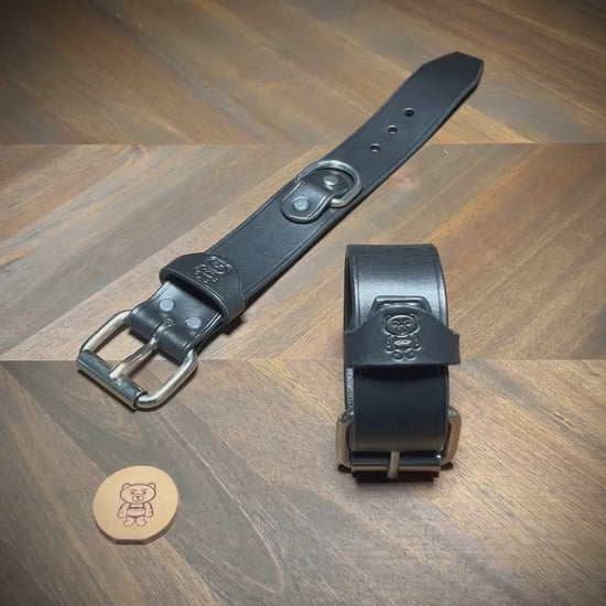 Unbuckling and fastening a 1.5" black leather cuff with steel hardware to demonstrate structural flexibility.