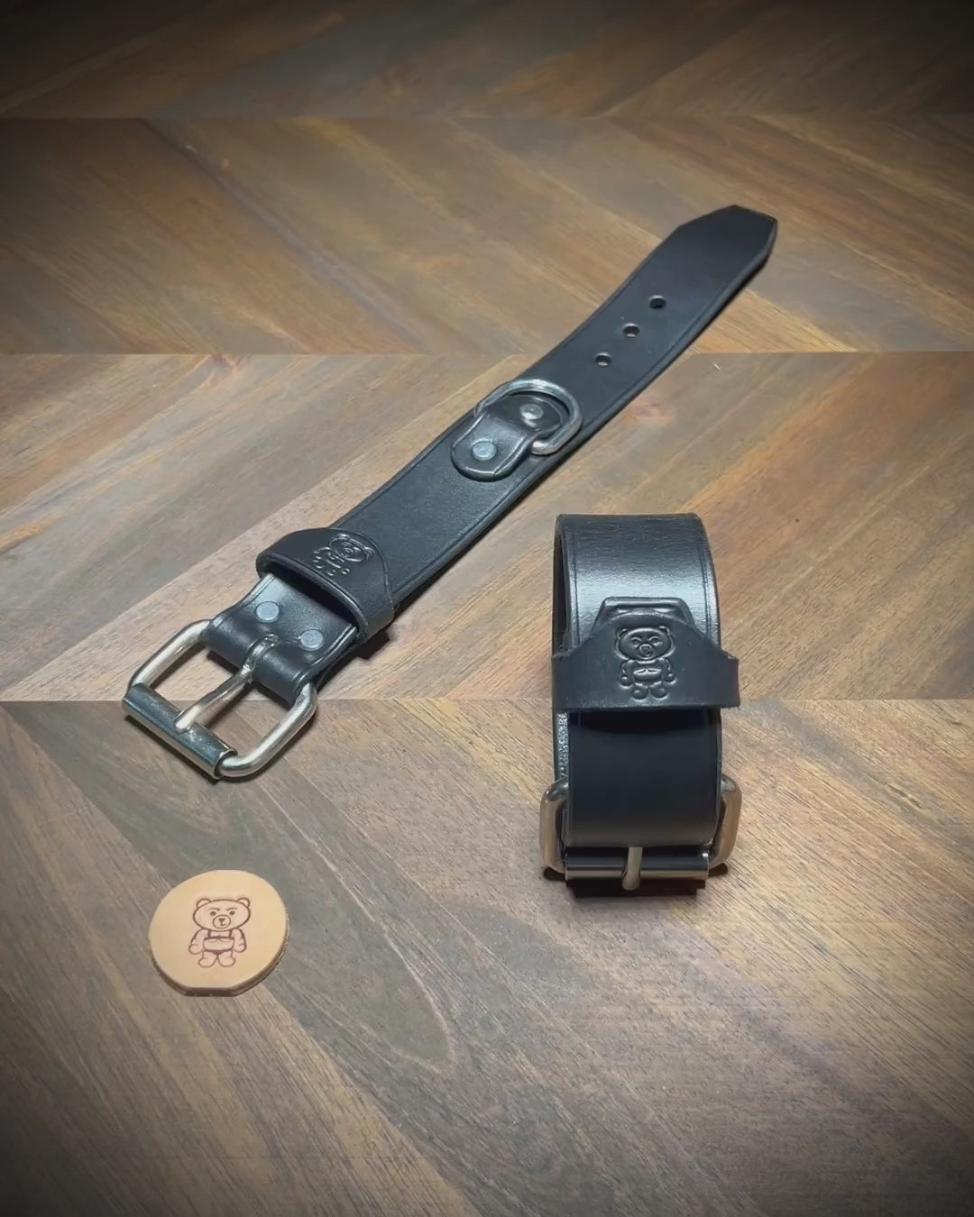 Unbuckling and fastening a 1.5" black leather cuff with steel hardware to demonstrate structural flexibility.