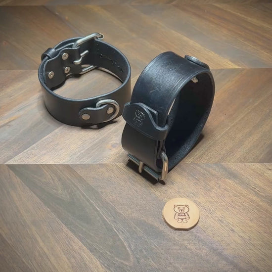 Hand-buckling and demonstrating the tensile hardware stability of a 1.75" black leather cuff with nickel-plated steel components.